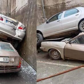 Rampadan geri kayıp 8 metrelik duvardan düştü: Park halindeki aracın üzerine çıktı