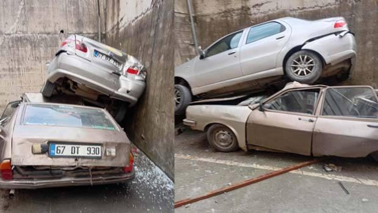 Rampadan geri kayıp 8 metrelik duvardan düştü: Park halindeki aracın üzerine çıktı