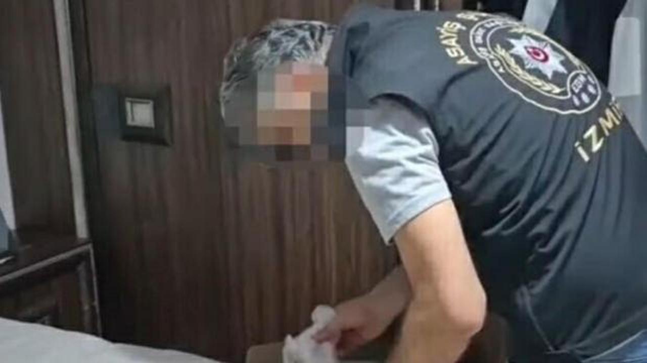 İzmir'de beyaz eşya servisi süsü verilerek yapılan dolandırıcılık operasyonunda zanlıların adliyeye sevk edilmesi.