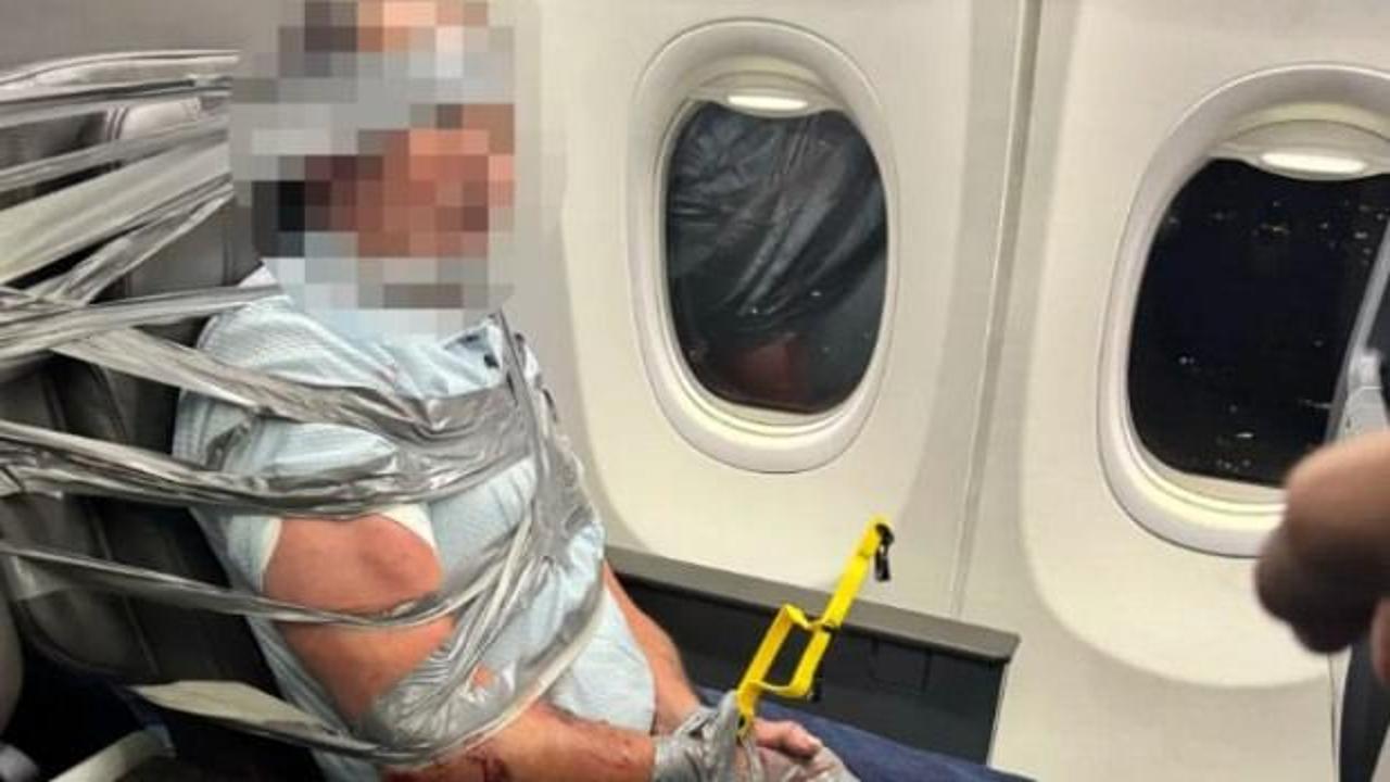 U&ccedil;akta taşkınlık yapan yolcuyu koli bandıyla bağladılar