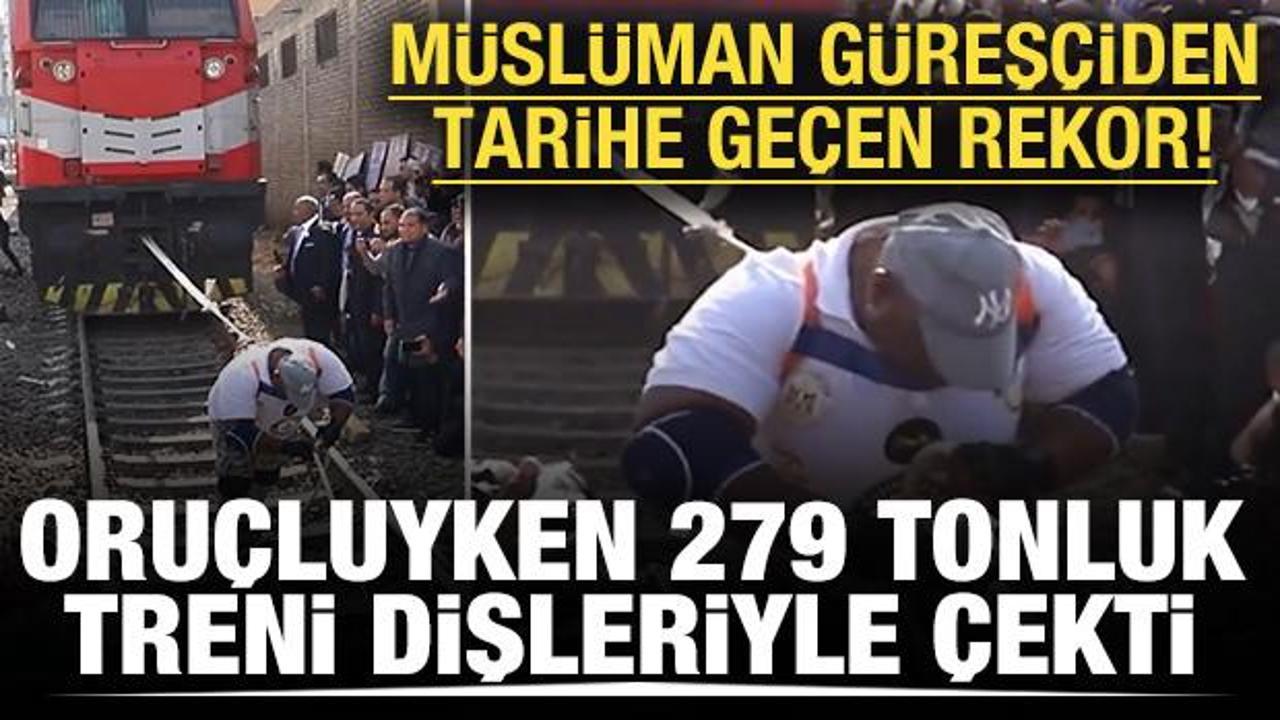 M&uuml;sl&uuml;man g&uuml;reş&ccedil;iden tarihe ge&ccedil;en rekor! Oru&ccedil;luyken 279 tonluk treni dişleriyle &ccedil;ekti